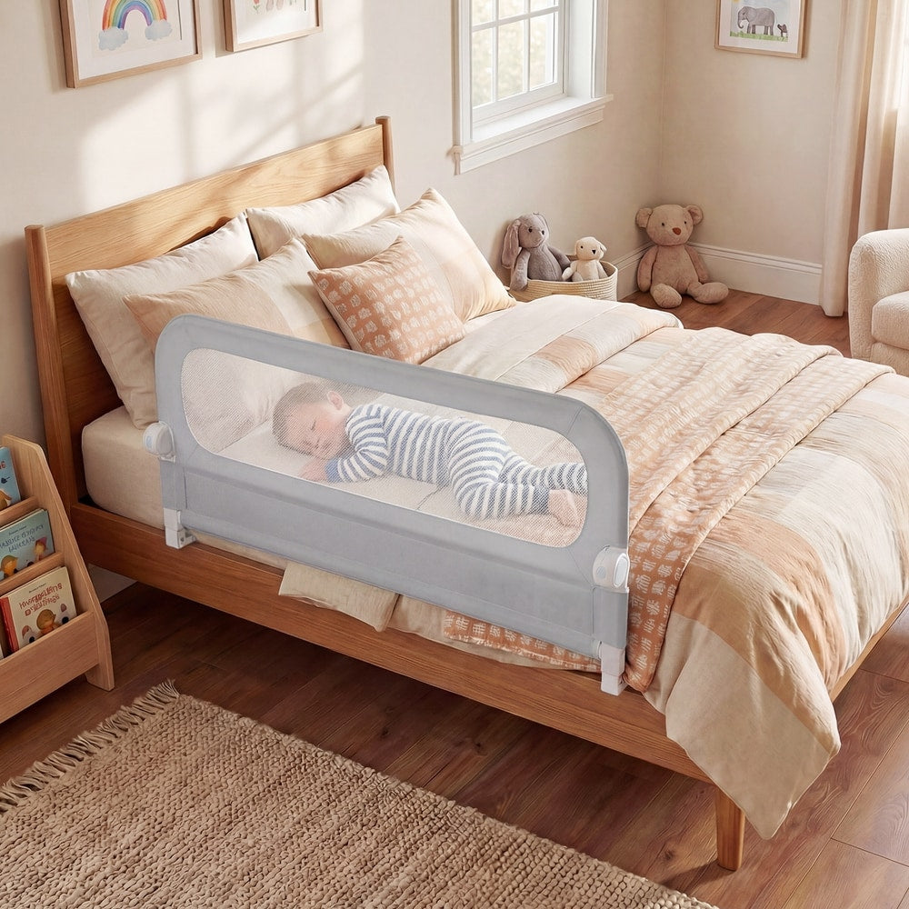 The foldable bed rail in use on a toddler bed with a baby sleeping