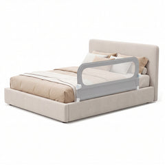 The bed rail fitted to the side of a modern upholstered double bed