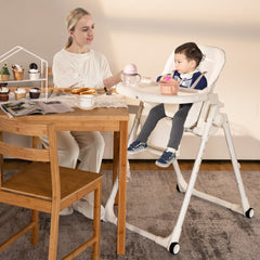 The high chair in use with a toddler sitting at a wooden dining table