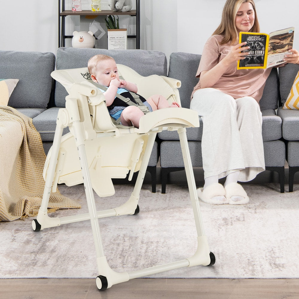 The high chair positioned in a living room with a child sitting inside
