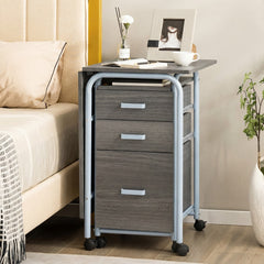 The compact office desk is placed next to a bed with drawers closed