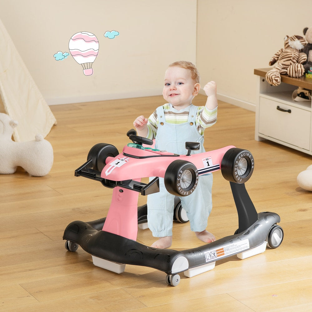 The baby walker in use with a toddler standing inside the pink racing car frame on a wooden floor