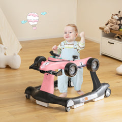 The baby walker in use with a toddler standing inside the pink racing car frame on a wooden floor