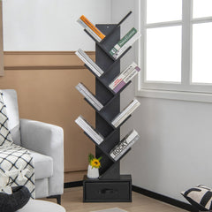 The black tree bookshelf with drawer is shown in a living room setting next to a sofa