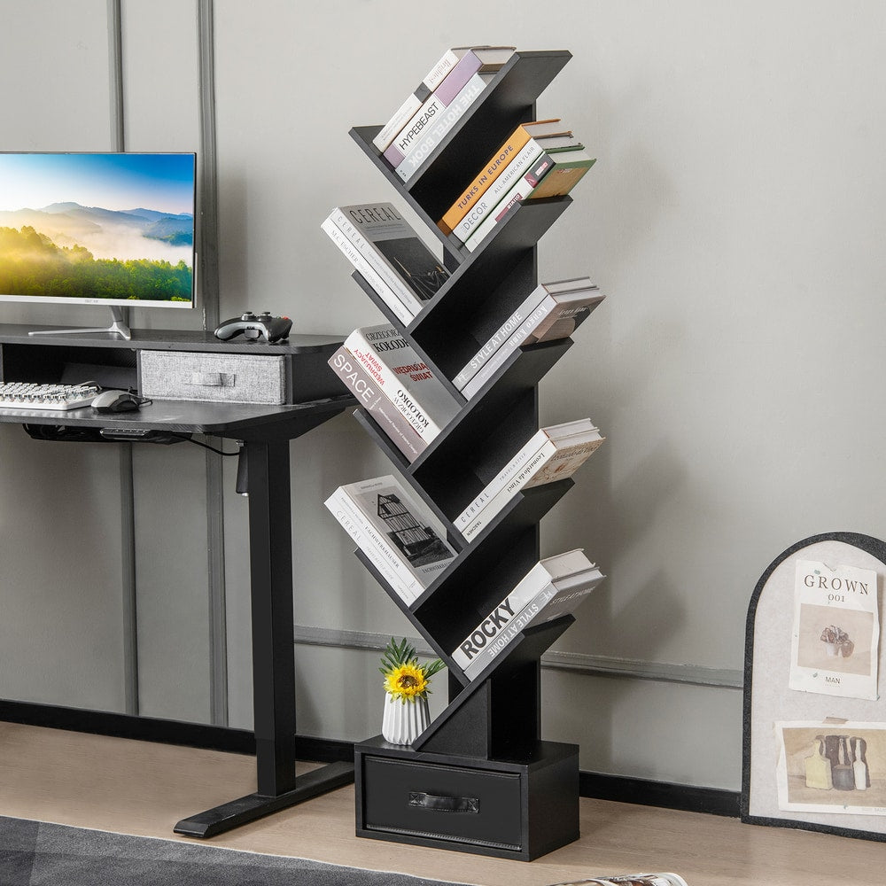The black tree bookshelf with drawer is placed next to a desk with a computer
