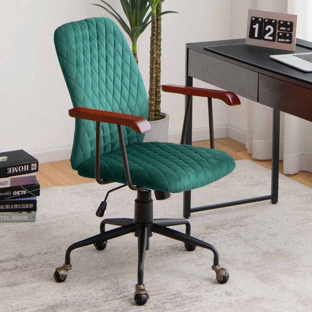 The green velvet office chair in a modern home office setting next to a desk