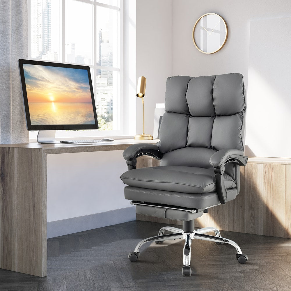 The office chair positioned in a bright home office setting with a desk and a window view