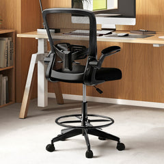 Black mesh office chair with footrest ring in a home office setting