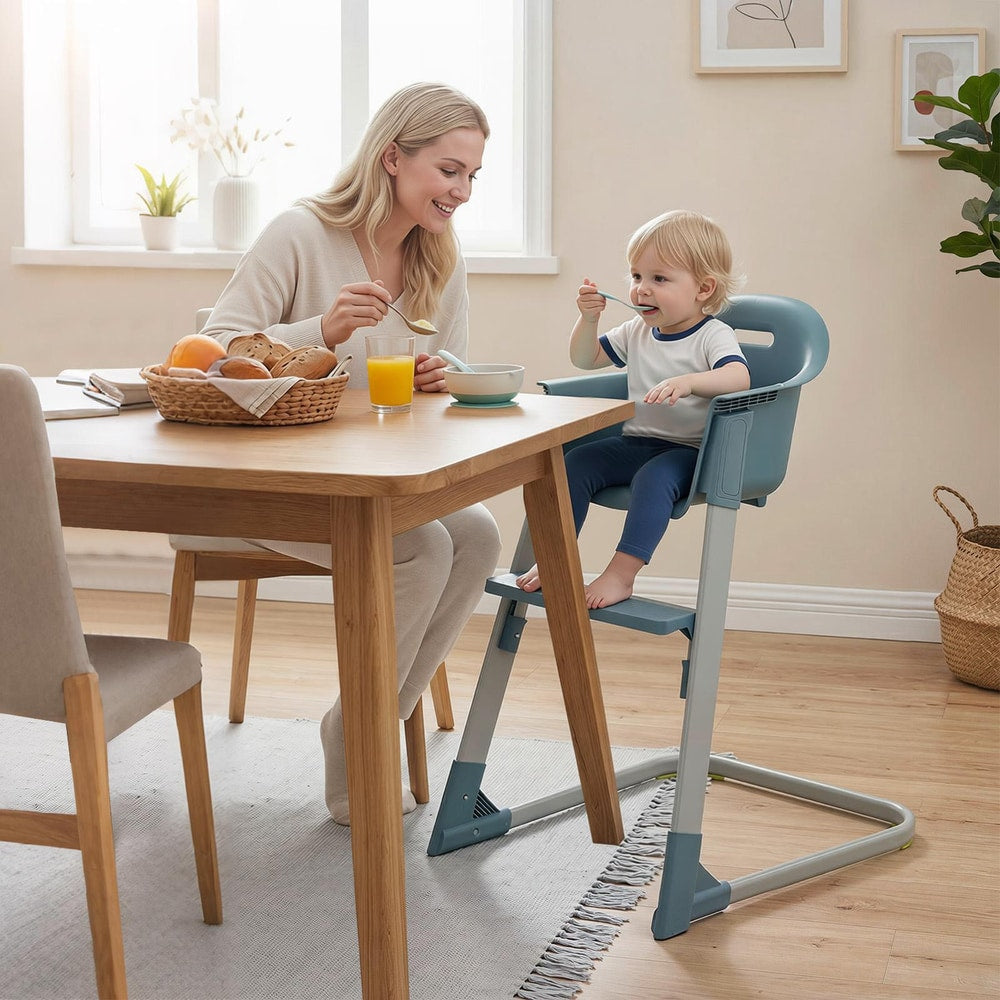 The high chair with a toddler sitting in it at a dining table during a meal