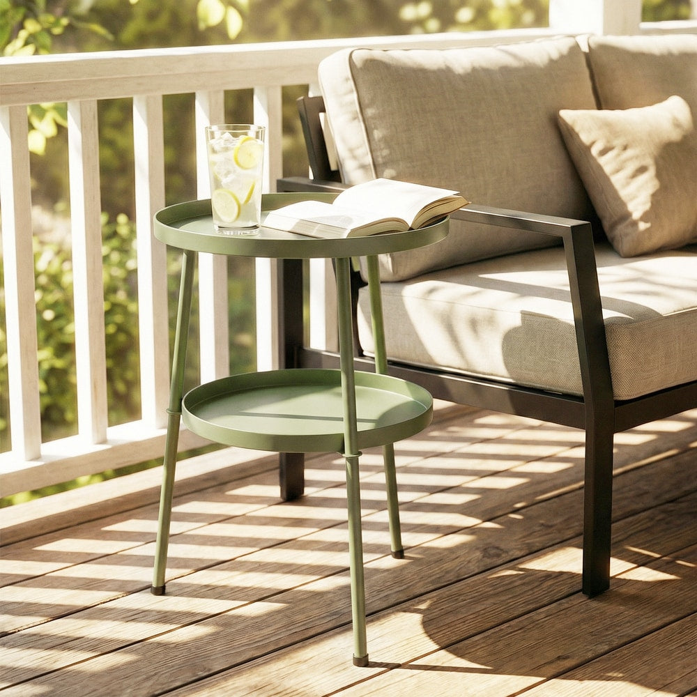The light green two-tier round coffee end table on a wooden deck