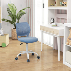 The kids chair placed in a bright study area next to a wooden desk and a large green plant
