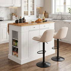 The kitchen island with drop-leaf countertop and two bar stools in a modern kitchen setting