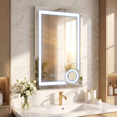 The illuminated bathroom mirror glowing with cool white light above a sink