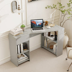 Grey L-shaped computer desk with open shelves and a drawer in a room