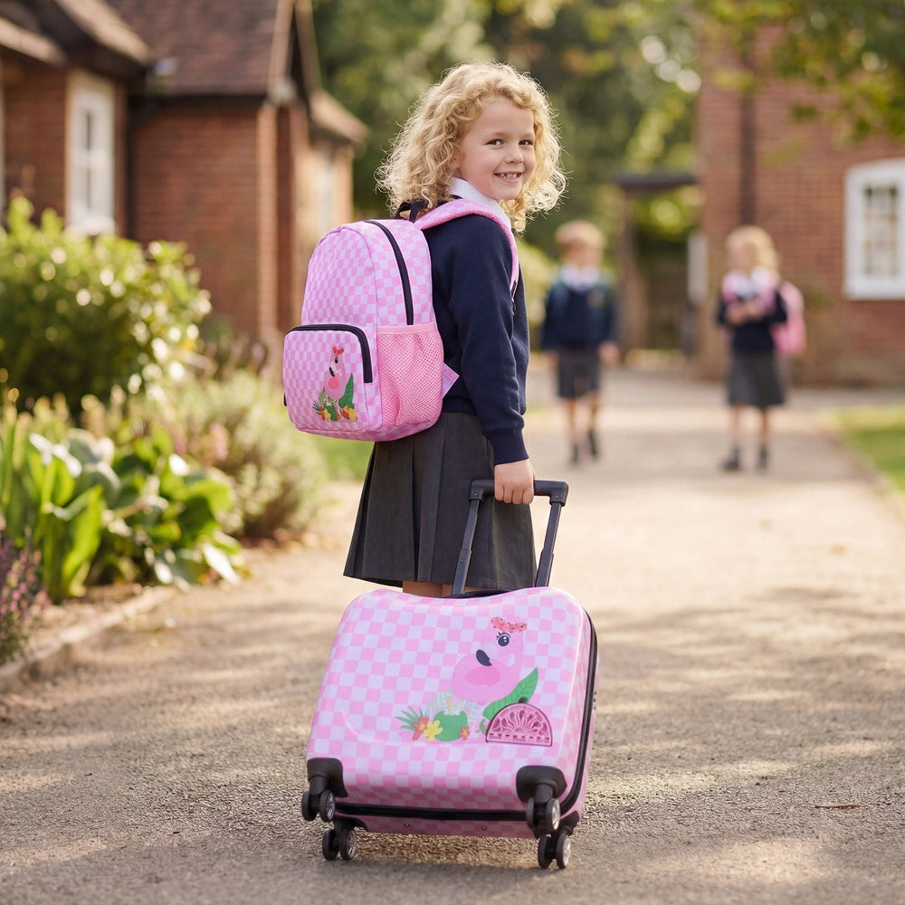 A young girl with a pink and white checkered kids luggage set with flamingo design
