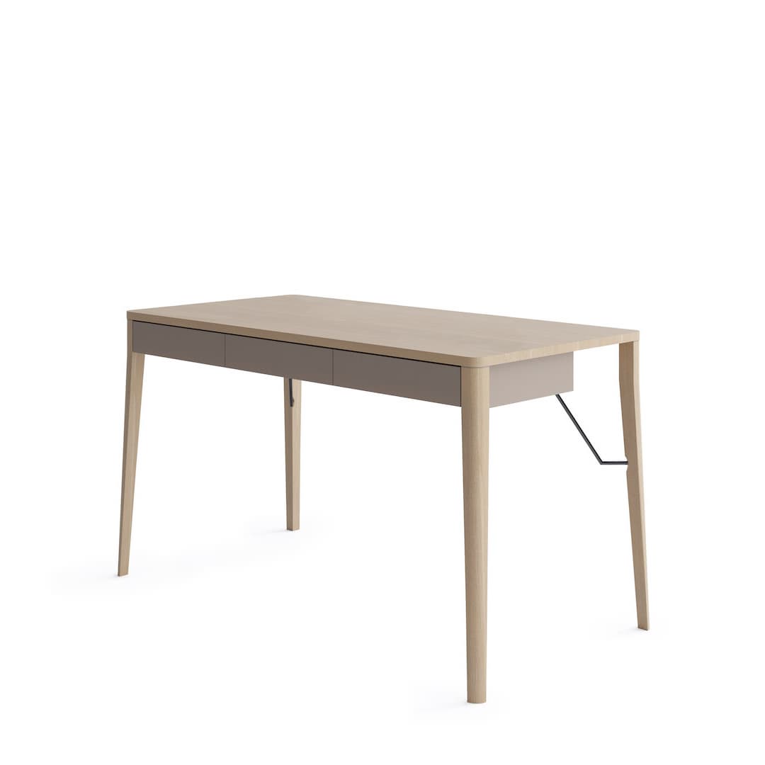 The wooden desk with a light finish and a slim drawer unit against a plain white background