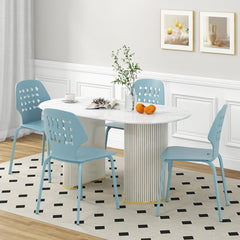Four blue metal dining chairs around a white oval dining table