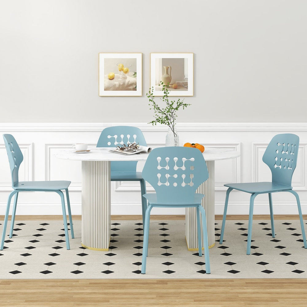 Four blue metal dining chairs arranged around a modern dining table