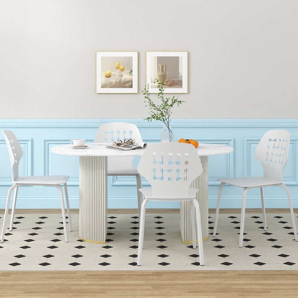 Four white metal dining chairs arranged around a modern dining table