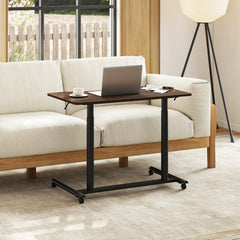 The mobile standing desk next to a sofa with a laptop on top