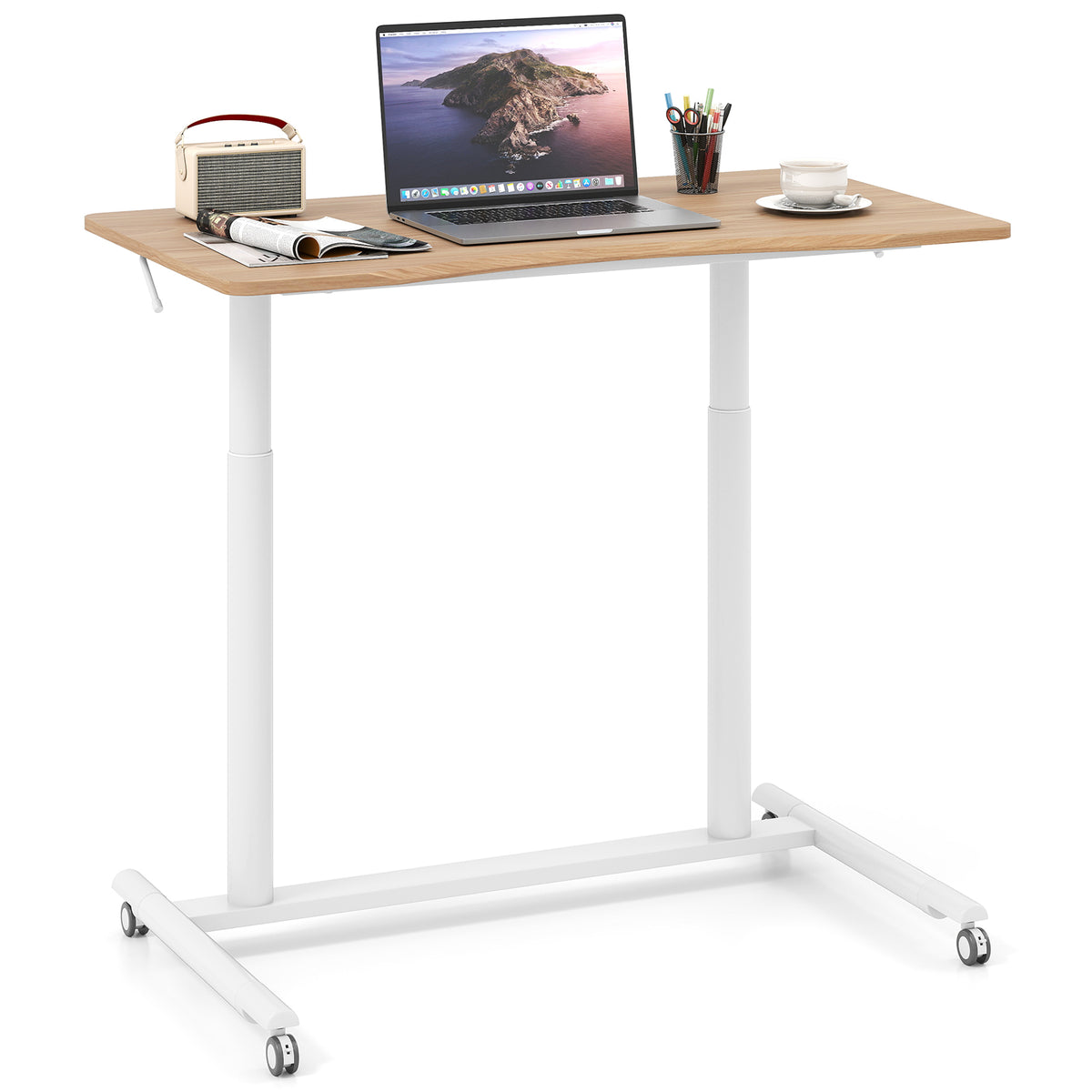 The standing desk with a laptop, radio and stationery on the surface