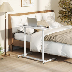 The office desk is positioned next to a bed, ready for use
