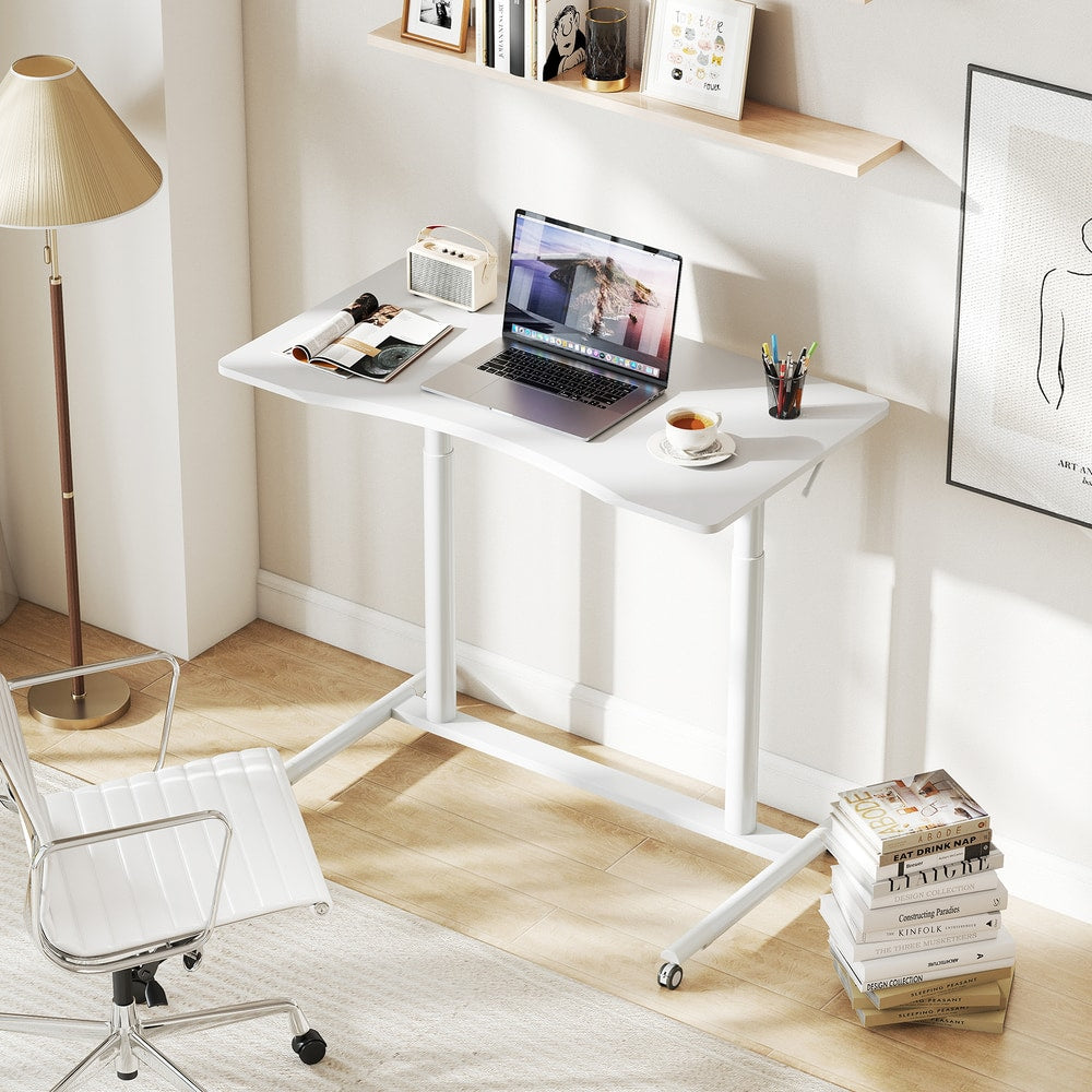 The white mobile standing desk is shown in a home office with a chair and books