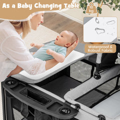 A woman changing a baby on the changing table attachment of the portable nursery center
