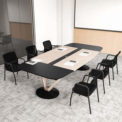 Several black office chairs arranged around a large meeting table in a conference room