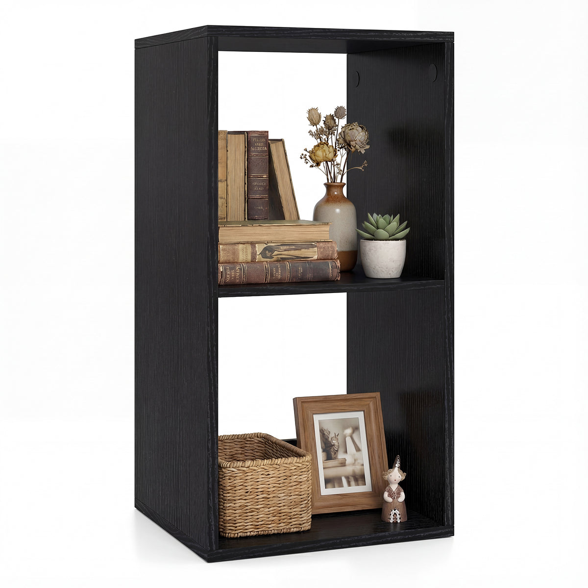 The black two-tier bookcase styled with books, a plant and decorative items