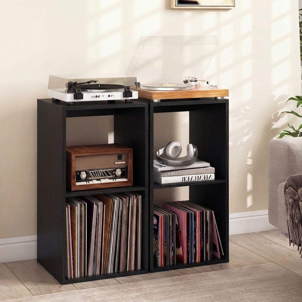 Two black two-tier bookcases used to store vinyl records and audio equipment