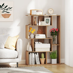The geometric bookcase styled with books and flowers next to a sofa in a bright living room