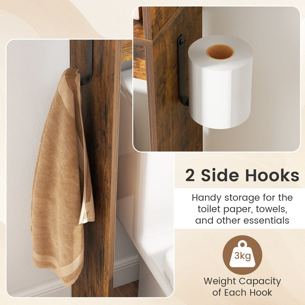 The side hooks on the over the toilet storage holding a towel and a roll of toilet paper