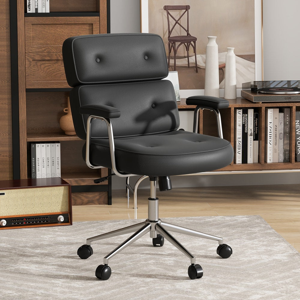 Black PU leather office chair with button tufted back, shown in a home office setting with bookshelves and a record player