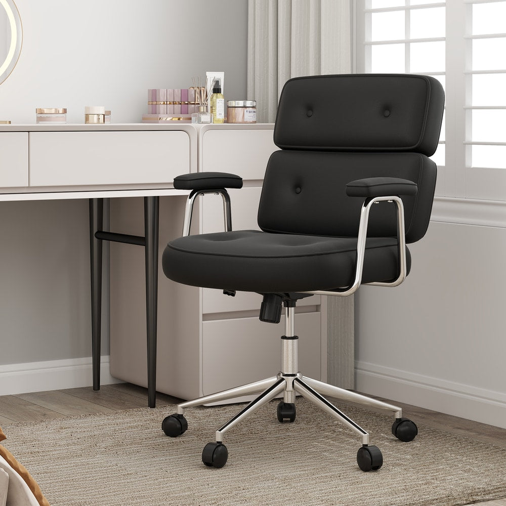The black office chair with button tufted back is shown next to a dressing table, highlighting its versatility