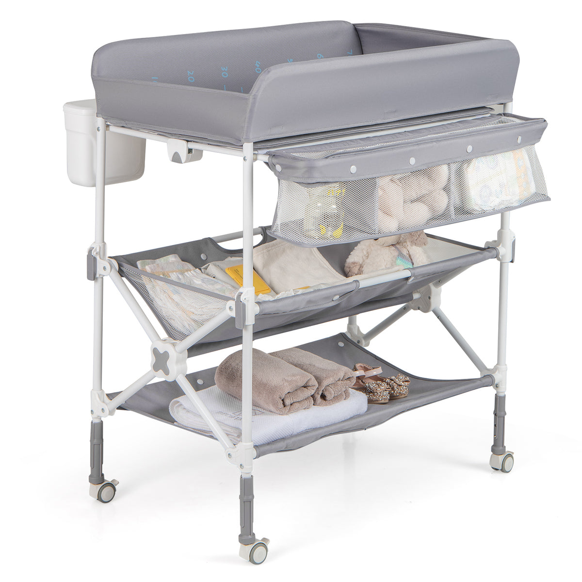 The changing table filled with baby essentials like nappies and towels on the lower shelves