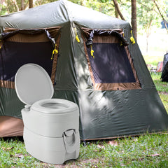The camping toilet set up outside a large tent in a woodland setting