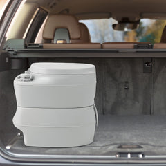 The portable toilet inside the boot of a car, ready for transport