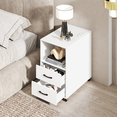 The nightstand with two drawers and a shelf, next to a bed with a lamp