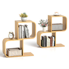 The bookcases styled with various books, a small potted plant, a clock and a storage basket