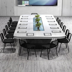 The office chairs set around a long white boardroom table with a central glass feature