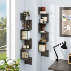 The bookcases mounted in a corner next to a window and a desk with a lamp