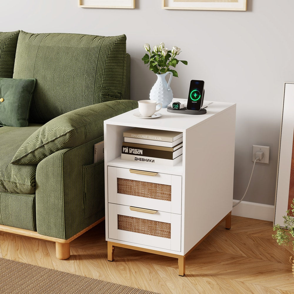 A white narrow end table next to a green sofa in a living room