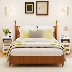 Two white narrow end tables in a bedroom setting either side of a bed