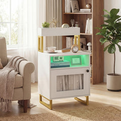 The nightstand with green LED lighting placed next to a comfortable armchair in a living room