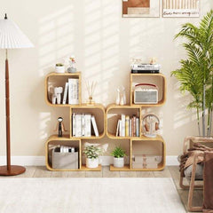 Two of the bamboo bookcases placed side by side against a wall with books and ornaments on shelves