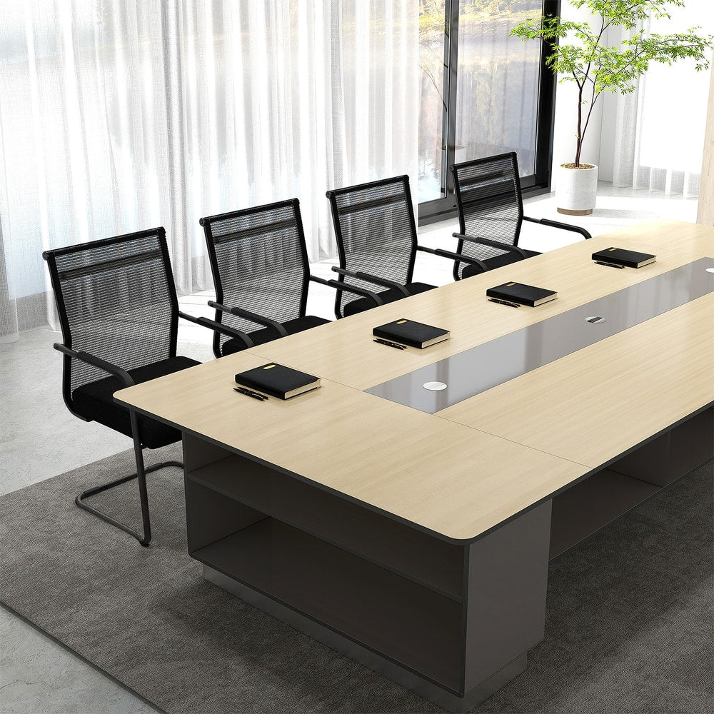 The office chairs positioned around a long wooden meeting table in a bright modern office