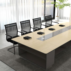 The office chairs positioned around a long wooden meeting table in a bright modern office