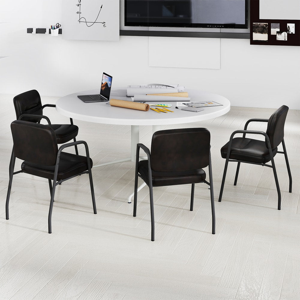 The office chairs positioned around a large white circular meeting table in a minimalist office room