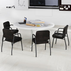The office chairs positioned around a large white circular meeting table in a minimalist office room